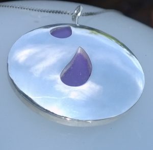 Silver pendant with purple colored tears